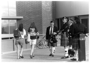 Bagpipers and students