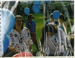 Peace walk participant with balloons and buttons