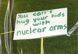 You can't hug your kids with nuclear arms protest sign